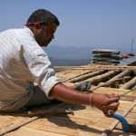 Fastening the bamboo chachra to the roof